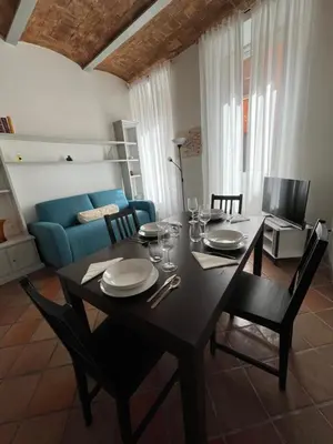 a living room with a table and a blue couch at TrastevereMoroni Gem in Rome