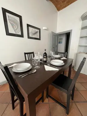 a dining room with a wooden table and chairs at TrastevereMoroni Gem in Rome