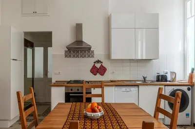 a kitchen with a table with a bowl of fruit on it at Casa Dandolo - Pretty Homes in Rome