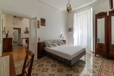 a bedroom with a bed and a living room at Casa Dandolo - Pretty Homes in Rome