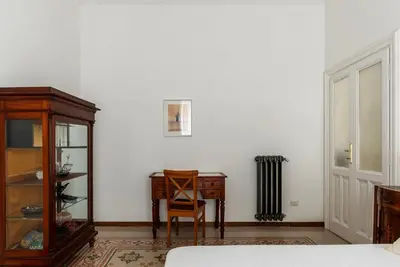 a bedroom with a table and a chair and a desk at Casa Dandolo - Pretty Homes in Rome