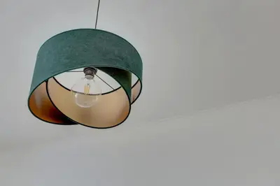 a green lamp hanging from a ceiling at Vatican Apt Doria 64 - Home and More in Rome