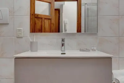 a bathroom with a sink and a mirror at Vatican Apt Doria 64 - Home and More in Rome