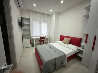 a bedroom with a bed and a table and a chair at BALDO 352 HOME in Rome