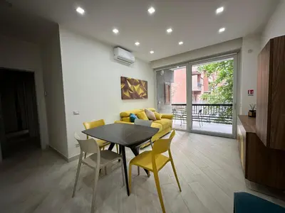 a living room with a table and a yellow couch at BALDO 352 HOME in Rome