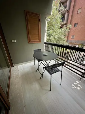 a table and two chairs sitting on a balcony at BALDO 352 HOME in Rome