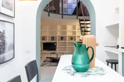 a green vase sitting on a table in a room at Domus Fori Imperiali in Rome