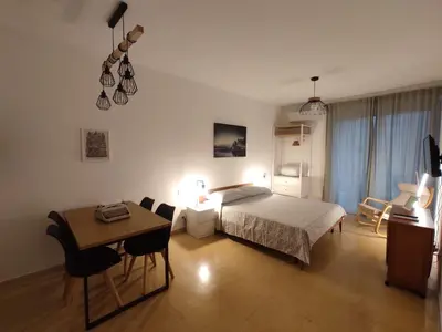 a bedroom with a bed and a table and a desk at Ponentino B&B in Rome