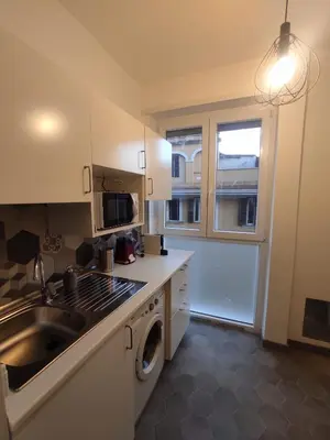 a kitchen with a sink and a washing machine at Ponentino B&B in Rome