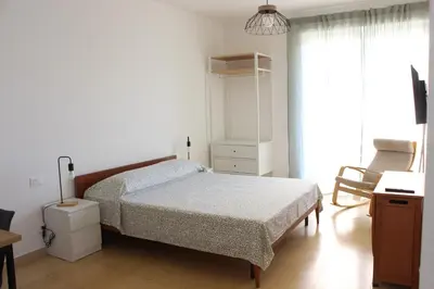 a bedroom with a bed and a desk and a chair at Ponentino B&B in Rome