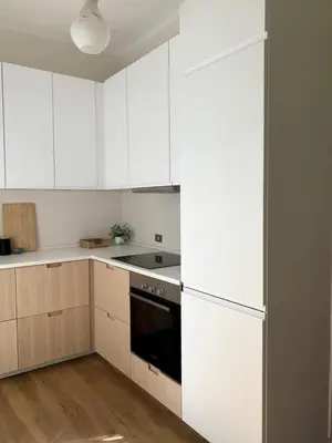 a kitchen with white cabinets and a stove top oven at Giardino dei Giganti, 5 minute walk to the subway B in Rome