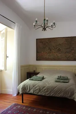 a bedroom with a bed with a painting on the wall at Giardino dei Giganti, 5 minute walk to the subway B in Rome