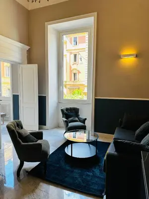 a living room with couches and a table and a window at Via Veneto Luxury House in Rome
