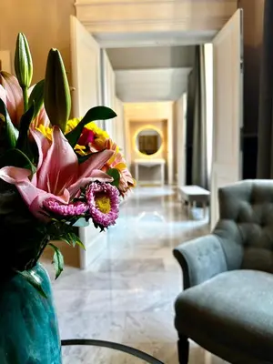 a vase with flowers on a table in a living room at Via Veneto Luxury House in Rome
