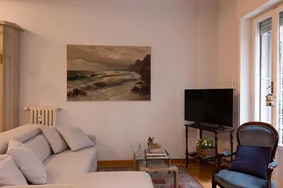 a living room with a couch and a television at Appartamento Coppedè in Rome