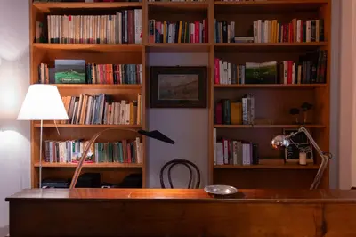 a book shelf filled with lots of books at Appartamento Coppedè in Rome