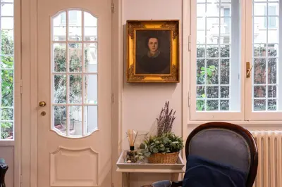 a room with a portrait of a man on the wall at Appartamento Coppedè in Rome