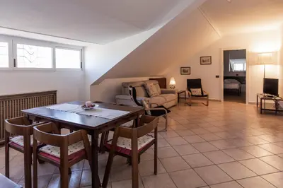 a living room with a table and a couch at FCR Rome Apartments Ponte Milvio - Fleming in Rome
