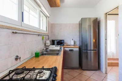 a kitchen with a sink and a refrigerator at FCR Rome Apartments Ponte Milvio - Fleming in Rome