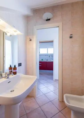 a bathroom with a white sink and a mirror at FCR Rome Apartments Ponte Milvio - Fleming in Rome