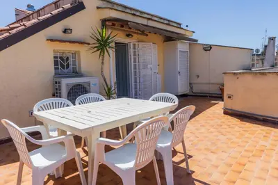 a white table and chairs on a patio at FCR Rome Apartments Ponte Milvio - Fleming in Rome