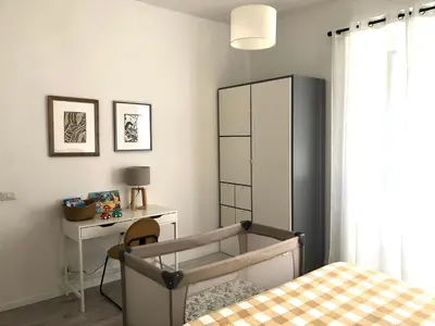 a bedroom with a bed and a cabinet and a desk at Eurialo Roma Design Apartment - MyItalianStay in Rome