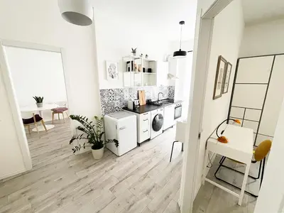 a white apartment with a kitchen and a dining room at Eurialo Roma Design Apartment - MyItalianStay in Rome