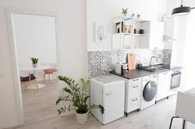a white kitchen with a sink and a dishwasher at Eurialo Roma Design Apartment - MyItalianStay in Rome