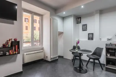 a living room with a table and a window at San Giovanni apartment in Rome