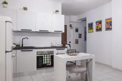 a kitchen with white cabinets and a sink and a stove at Casa Daniela in Rome