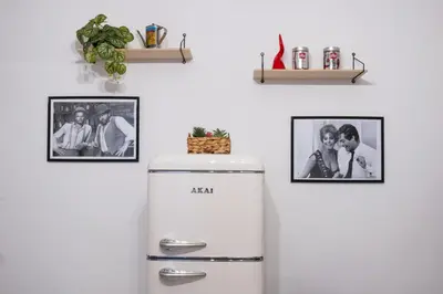 a refrigerator in a kitchen with pictures on the wall at Casa Daniela in Rome