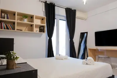 a bedroom with a bed and a tv and a window at Casa Daniela in Rome