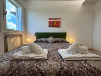 a bedroom with a large bed with two pillows on it at Rome at Hand in Rome