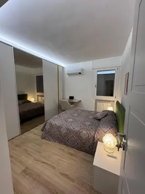 a bedroom with a bed and a table and a mirror at Rome at Hand in Rome