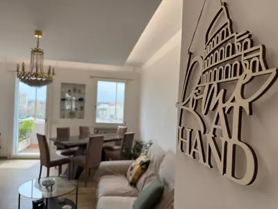 a living room with a couch and a dining room at Rome at Hand in Rome