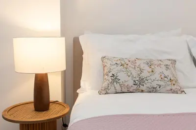 a bed with a lamp and a pillow on it at 25 Penthouse Porta Pia in Rome