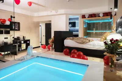 a living room with a swimming pool and a bedroom at Dream Suite Trevi in Rome