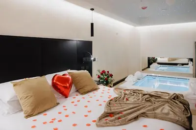 a bedroom with a bed with a jacuzzi tub at Dream Suite Trevi in Rome