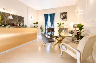 a dining room with a table and chairs at Madame Sofia Exclusive Collection Spanish Steps - HOME Apartment-Suites in Rome