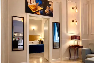 a living room with a mirror and a bedroom at Madame Sofia Exclusive Collection Spanish Steps - HOME Apartment-Suites in Rome