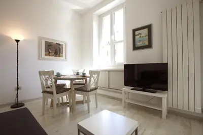 a living room with a table and a tv at Testaccio View Holiday House in Rome