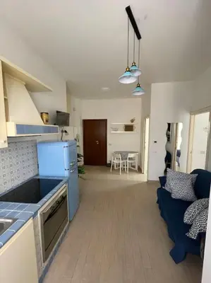 a kitchen and a living room with a blue refrigerator at casa celeste, Roma in Rome