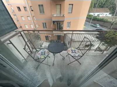 a patio with a table and chairs on a balcony at casa celeste, Roma in Rome
