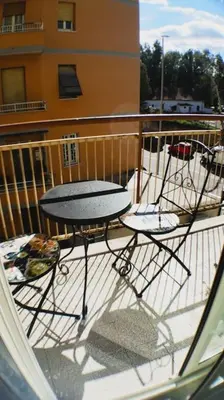 two chairs and a table on a balcony at casa celeste, Roma in Rome
