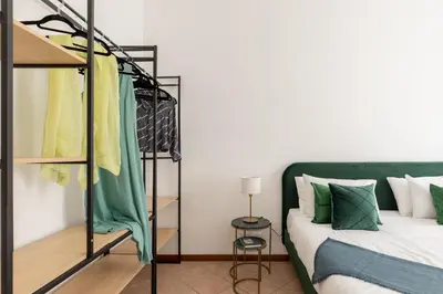 a bedroom with a bunk bed with green and white pillows at iFlat Comfortable Apartment next to the Vatican in Rome