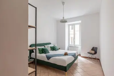 a bedroom with a bed with green pillows at iFlat Comfortable Apartment next to the Vatican in Rome