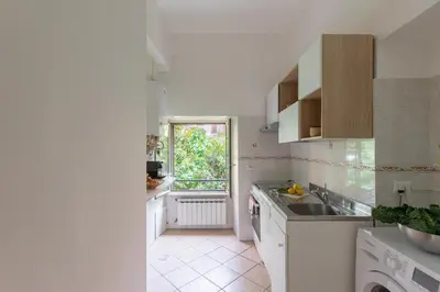 a white kitchen with a sink and a window at iFlat Comfortable Apartment next to the Vatican in Rome