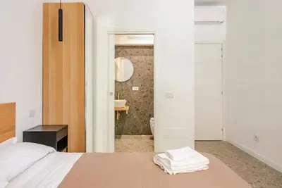 a bedroom with a bed and a bathroom with a shower at Roma private rooms Vatican City in Rome