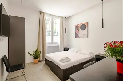 a small bedroom with a bed and a desk at Roma private rooms Vatican City in Rome