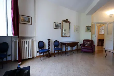 a room with chairs and a table and a mirror at Casa Salimei in Rome